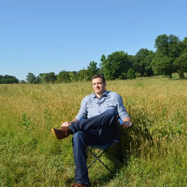 Matt Bowyer sitting in open landscape